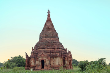 Fototapeta na wymiar Ancient pagoda in the landscape from Bagan in Myanmar at sunrise