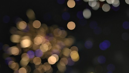 Light blur and defocus bokeh circles on black sky background