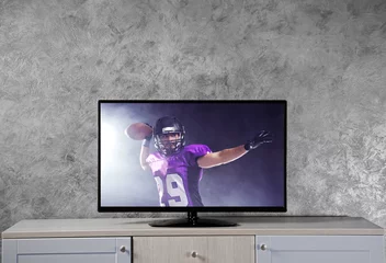 Foto op Plexiglas Watching American football game on television at home. Leisure and entertainment concept. © Africa Studio