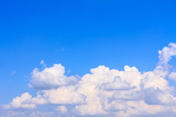 Blue sky background with white clouds and rain clouds. The vast blue sky and clouds sky on sunny day. White fluffy clouds in the blue sky.