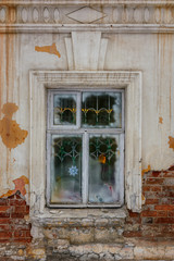 Window in an old house, brick walls with crumbling plaster