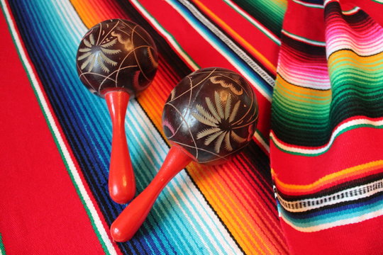 Mexican blanket maracas poncho Mexico traditional cinco de mayo rug poncho fiesta background with stripes stock, photo, photograph, image, picture