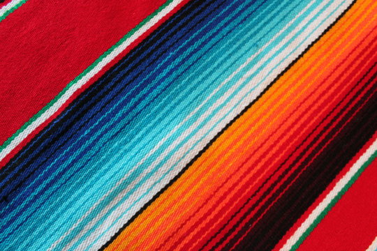 poncho Mexican cinco de mayo rug blanket serape fiesta traditional Mexico poncho background Mexican stripes copy space blanket minimal simple cinco de mayo serape pattern background  -  stock photo