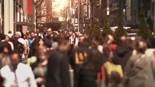 Lots of people walking on  a crowded sidewalk in Manhattan. New York, USA.