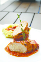 Close up of grilled chicken with tomato sauce. Selective focus, vertical.
