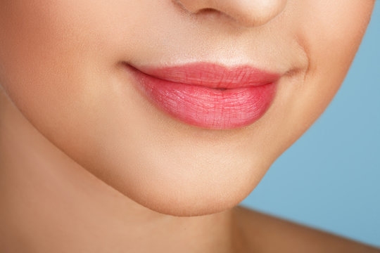 Perfect natural lip makeup. Close up macro photo with beautiful female mouth. Plump full lips. Close-up face detail. Perfect clean skin, light fresh lip make-up. Beautiful spa tender lip