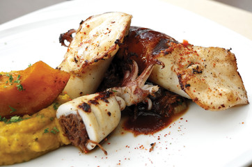 Close up of stuffed calamari with braised oxtail. Selective focus.
