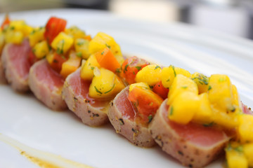 Close up of tuna with mango salsa. Selective focus.
