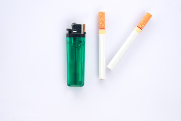 Cigarette and lighter on white background