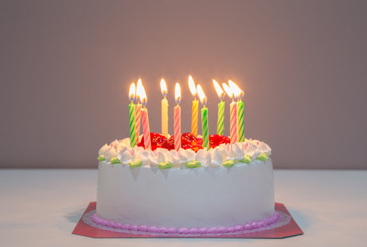 white biirthday cake with candles