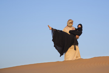 Couple in traditional clothing in a desert near Dubai