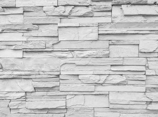 Closeup surface brick pattern at old stone brick wall textured background in black and white tone