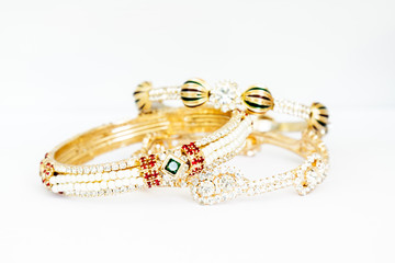 Gold bracelets with gem and diamonds isolate on white background.