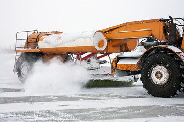 Close-up airfield sweeper on the runway