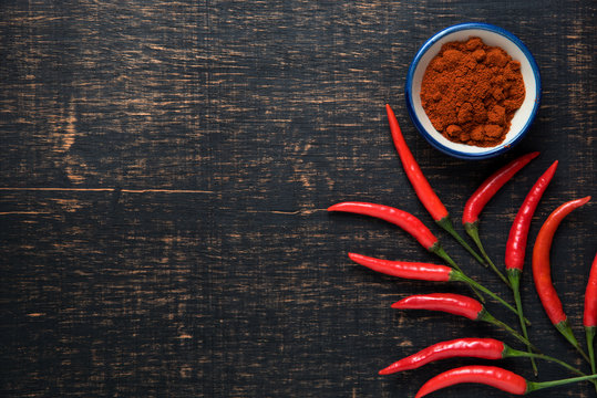 Red chilli on dark wooden table background. food concept