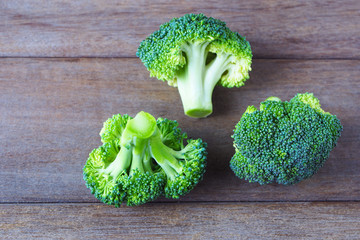Close up of fresh green broccoli on a wooden background.