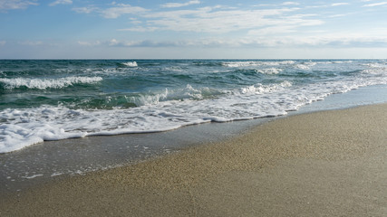 Fototapeta na wymiar View on Mediterranean Sea with sunny sand beach. Nei Pori village, Pieria, Greece.