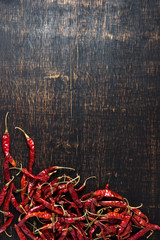 Dried hot red chilli peppers on dark background. asian food, healthy or cooking concept.