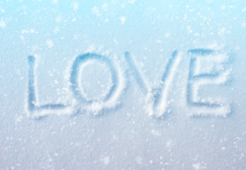 word "LOVE" in the fresh blue snow with snowfall effect
