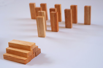 Wooden block stacking as step stair with planning in business model ladder success.