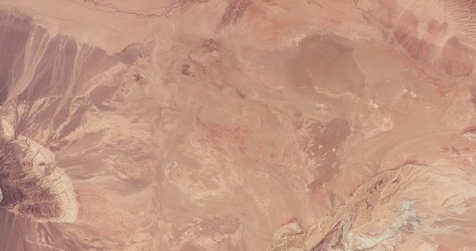 High-altitude overflight aerial of Iran's Dasht-e Kavir (Great Salt Desert). Clip loops and is reversible. Elements of this image furnished by USGS/NASA Landsat 
