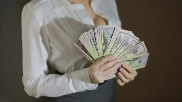 Beautiful young slim girl considers money