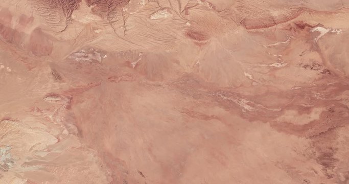 High-altitude overflight aerial of Iran's Dasht-e Kavir (Great Salt Desert). Clip loops and is reversible. Elements of this image furnished by USGS/NASA Landsat 
