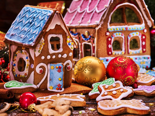 Small gingerbread house closeup. In the background, a large gingerbread house. Happy New Year and New Year's still-life.