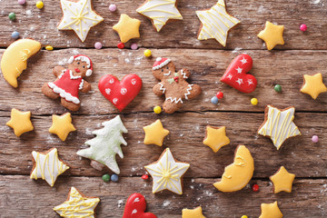 Beautiful gingerbread Christmas: stars, man, moon, tree on a wooden background. horizontal top view