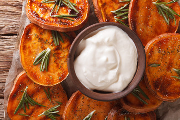 roasted sweet potato with sour cream closeup. horizontal top view