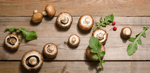 Fresh mushrooms with leaves of arugula