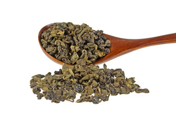 Dry green tea in wooden spoon isolated on white background