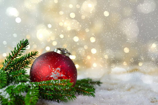 Red christmas tree ball at snow