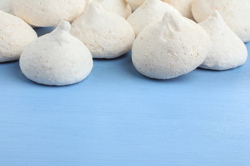 Fototapeta na wymiar Coconut meringue on a blue background. Copy space