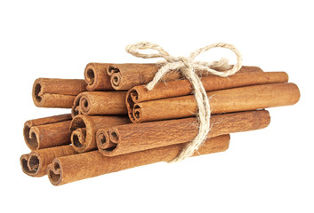 Cinnamon sticks tied with a natural rope, isolated on white back