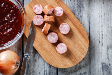 Ingredients ready for preparing German currywurst with curry sau