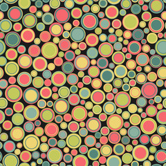 Seamless pattern. Consists of geometric elements having round shape and different color, located on black background. Useful as design element for texture and artistic compositions.