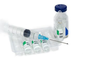 Hypodermic needle with drop on medical syringe and medication ampules