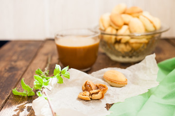 nuts cake with condensed milk and coffee on the table, selective focus