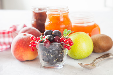 berries, fruit and jam on a table, selective focus