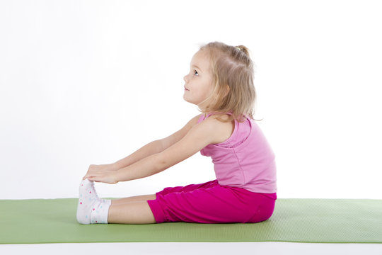 child doing gymnastics on a mat
