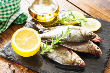 fish with a lemon and tomatoes on a table, selective focus