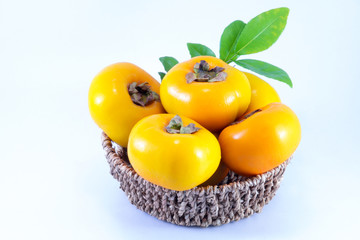 ripe persimmon fruit on rustic wooden table in vintage color eff
