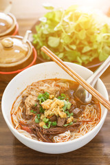Rice noodles with spicy pork sauce (Nam ngiao) is a noodle soup or curry of the cuisine of the Tai Yai people. Nam ngiao has a characteristic spicy and tangy flavor. Thai food.