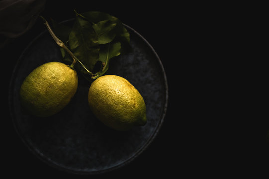 Fresh ripe citrus. Lemons, limes on dark background