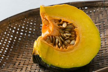 slice pumpkin on wooden wicker background