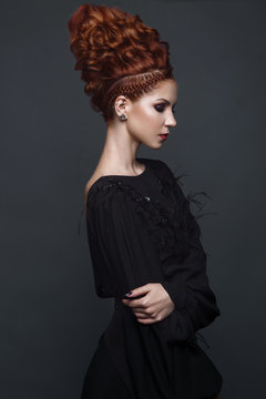 Beautiful girl in evening dress with avant-garde hairstyles. Beauty the face. Photos shot in the studio.
