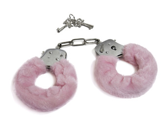 Pink handcuffs and keys isolated on white