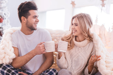 Positive cheerful couple having tea