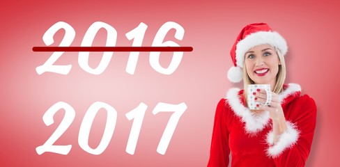 Composite image of festive blonde holding a mug